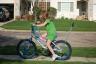 Callie working on riding without training wheels (check out the cool handle)
