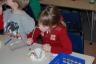 Transferring M&Ms and marshmallows to the cups