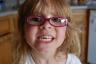 Julia's front tooth is hanging way down but she won't let us pull it